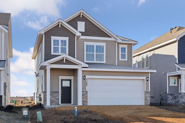 craftsman-style home with a garage and stone siding