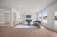 living area with recessed lighting, a fireplace, and wood finished floors