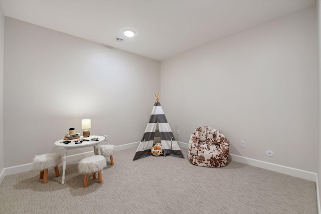 playroom featuring carpet floors and baseboards