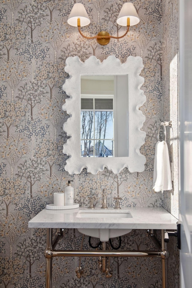 details with wallpapered walls and a sink