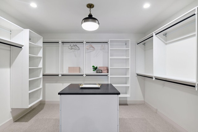 walk in closet with light carpet