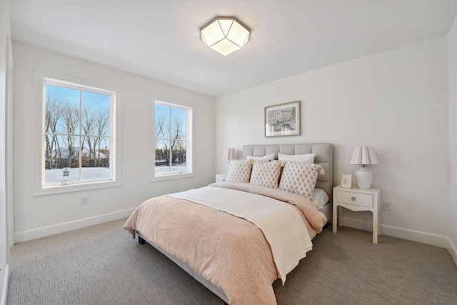 bedroom with carpet floors and baseboards