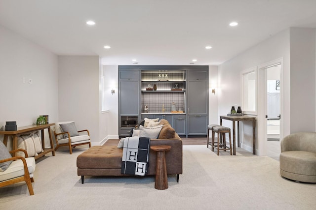 living room featuring baseboards, light colored carpet, and recessed lighting