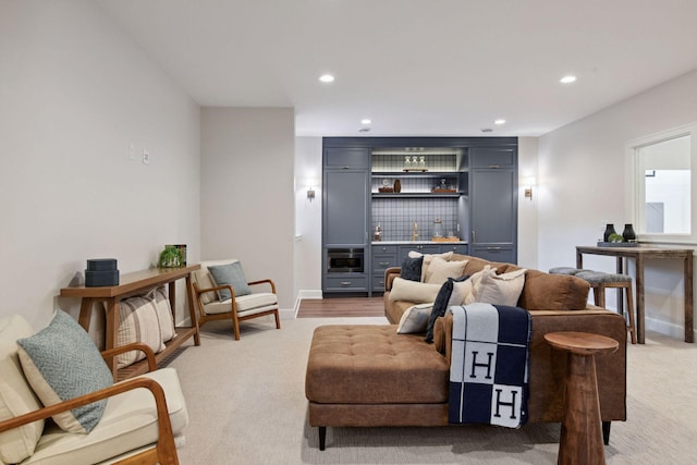 living area with baseboards, light colored carpet, and recessed lighting