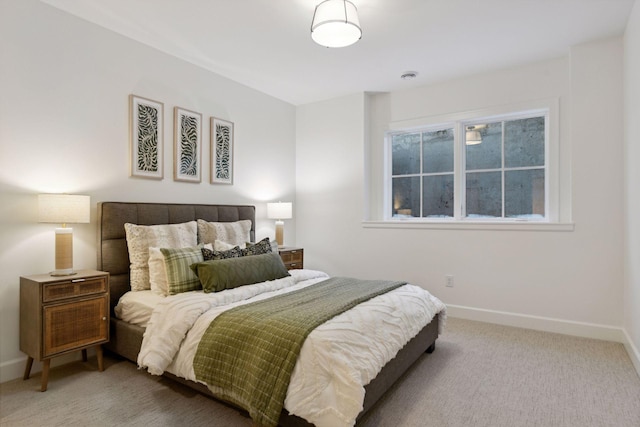 carpeted bedroom featuring baseboards