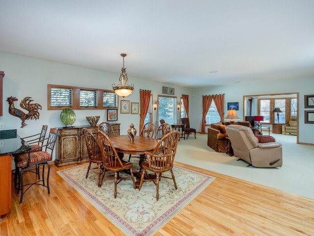 dining room with a wealth of natural light and light wood-style floors