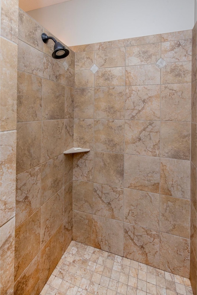 interior details with a tile shower