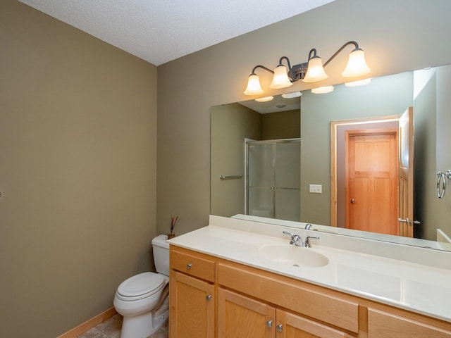 full bathroom featuring baseboards, toilet, tile patterned floors, an enclosed shower, and vanity