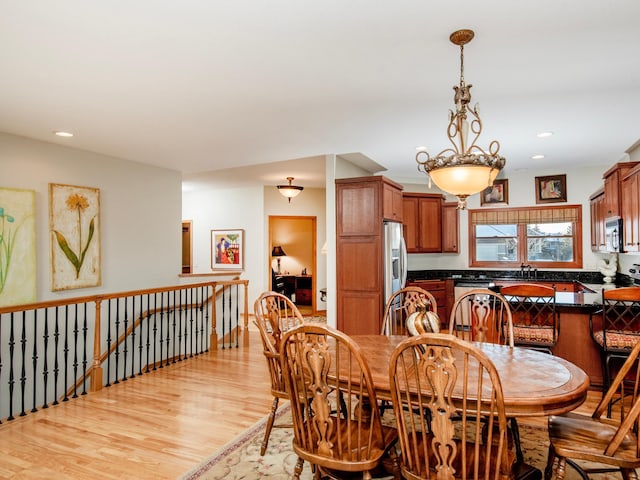 dining space featuring light wood-style flooring and recessed lighting