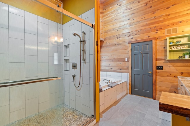 bathroom with a shower stall, visible vents, and wood walls