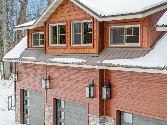 view of snow covered exterior featuring metal roof