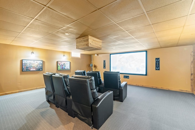 home theater room with carpet floors, a paneled ceiling, and baseboards