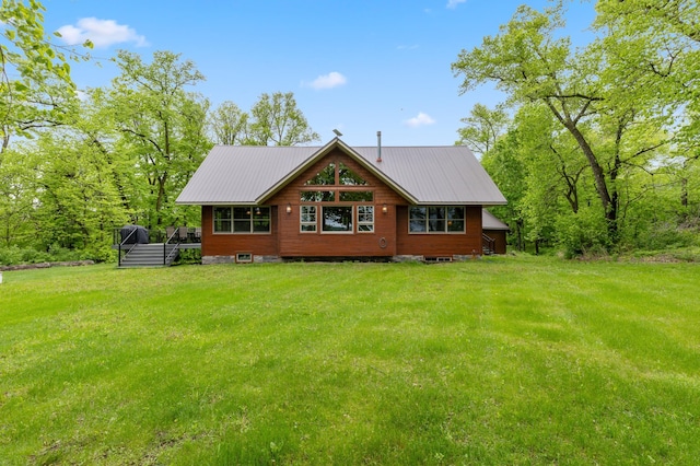 view of front of home featuring a wooden deck, metal roof, and a front yard