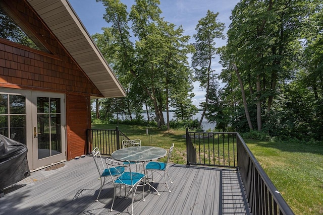deck featuring a yard and outdoor dining space