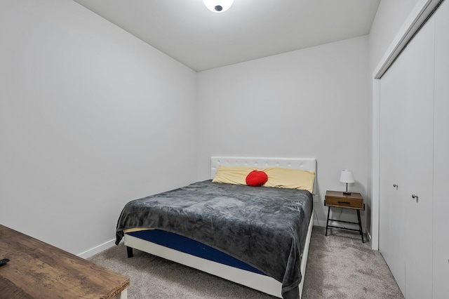 carpeted bedroom featuring baseboards