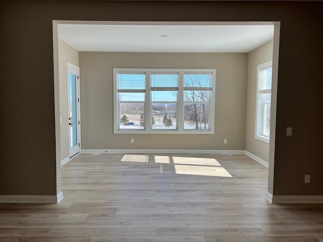 empty room featuring light wood-style flooring and baseboards