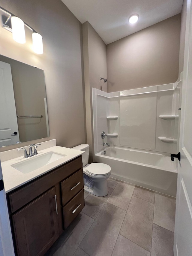 bathroom with tile patterned floors, bathing tub / shower combination, toilet, and vanity