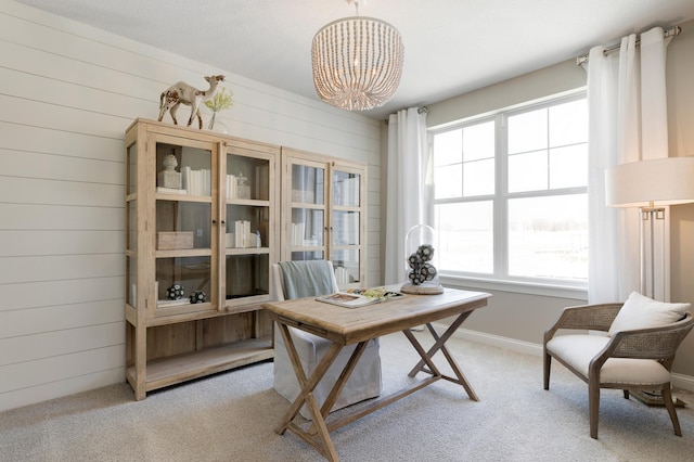 office with light carpet, wooden walls, and baseboards