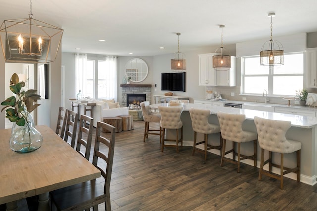 kitchen with a kitchen island, pendant lighting, white cabinets, and dark wood-style flooring