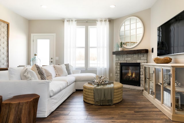 living area featuring a fireplace, dark wood finished floors, and recessed lighting