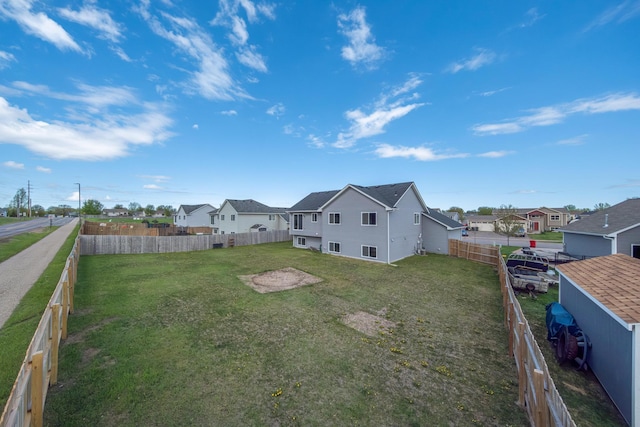 view of yard featuring a residential view and a fenced backyard