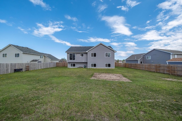 back of property featuring a residential view, a fenced backyard, and a lawn