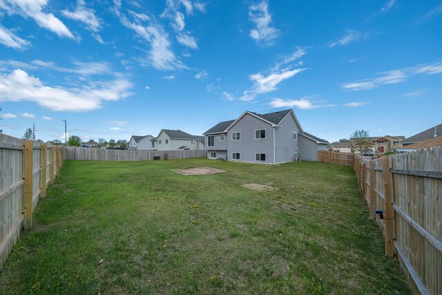 view of yard with a residential view and a fenced backyard