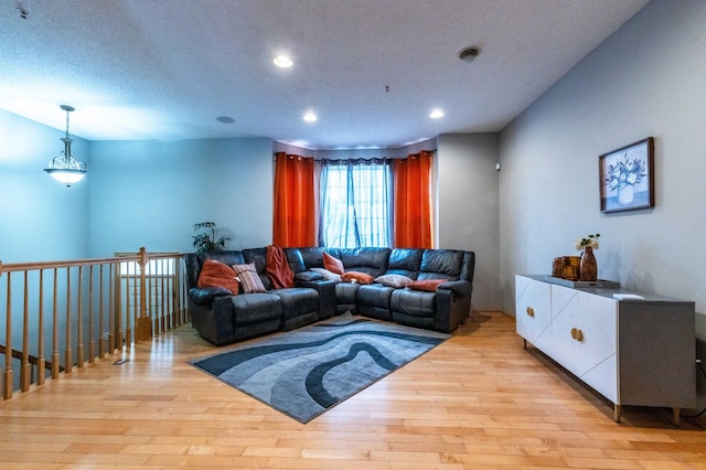 living area with recessed lighting and light wood-style floors