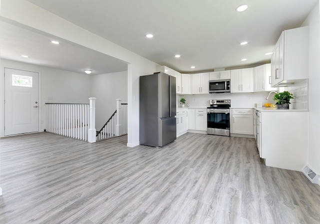 kitchen featuring visible vents, light countertops, appliances with stainless steel finishes, and white cabinetry