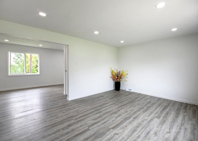 unfurnished room with recessed lighting, baseboards, visible vents, and light wood finished floors