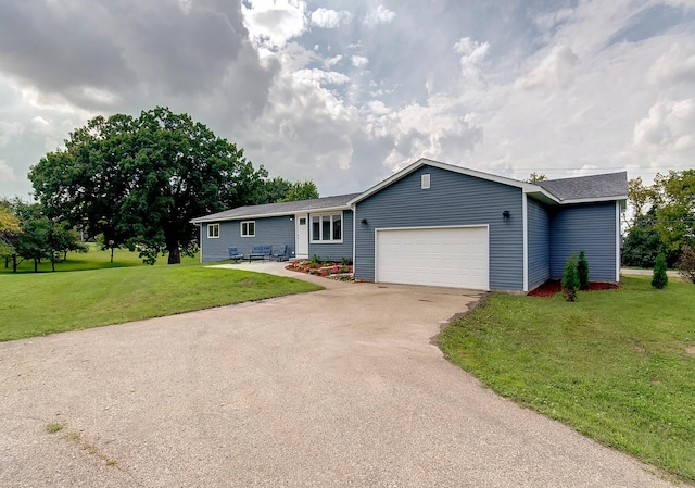 ranch-style house featuring an attached garage, driveway, and a front lawn