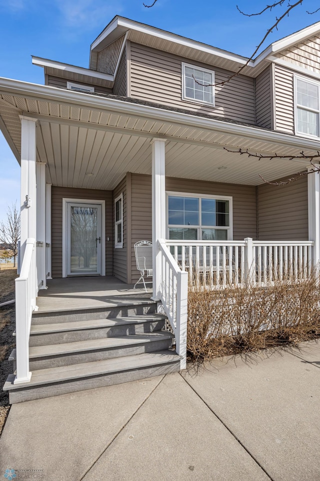 entrance to property featuring a porch