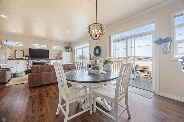 dining space with a notable chandelier, a textured ceiling, crown molding, and dark wood-style flooring