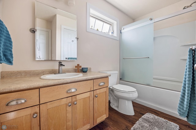 full bathroom with enclosed tub / shower combo, toilet, vanity, and wood finished floors