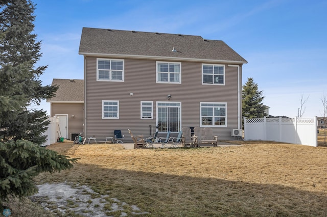 back of property featuring a lawn, a patio, fence, cooling unit, and a shingled roof