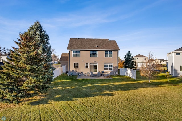 rear view of property featuring a fenced backyard, a patio, and a yard