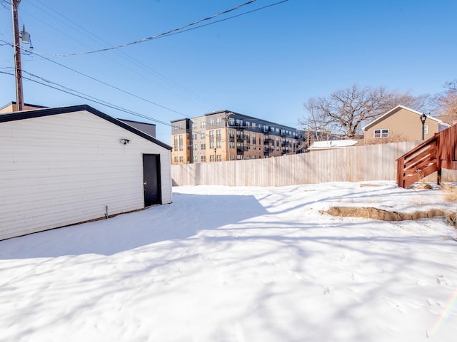 yard layered in snow with fence