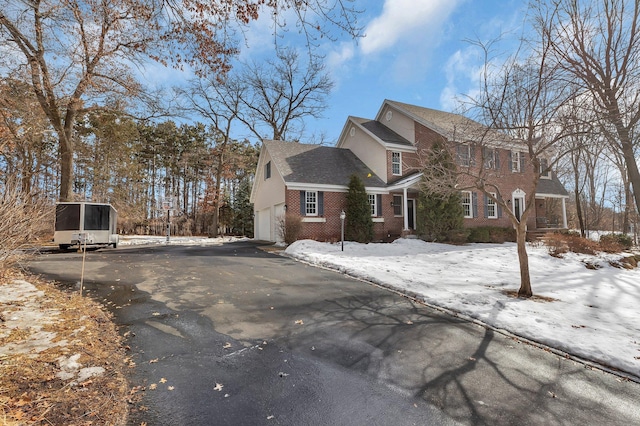 exterior space featuring brick siding and driveway