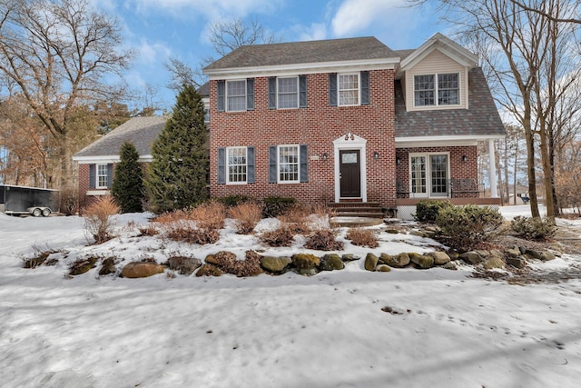 view of front of house with brick siding and a shingled roof