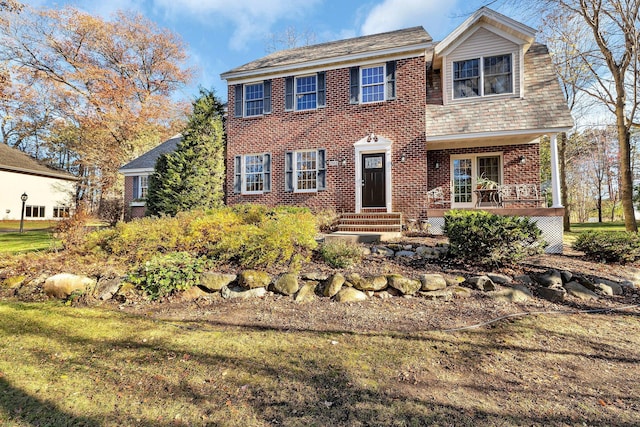 view of front facade with a front lawn and brick siding