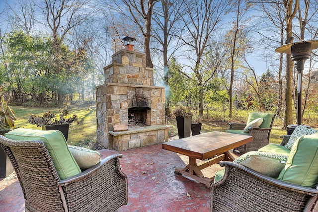 view of patio featuring outdoor dining space and an outdoor stone fireplace