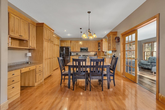 dining space featuring light wood finished floors, recessed lighting, a notable chandelier, and built in study area