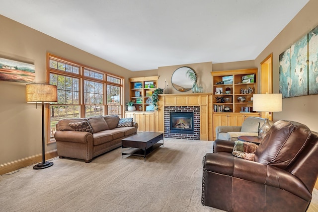 living area featuring carpet, a brick fireplace, and baseboards