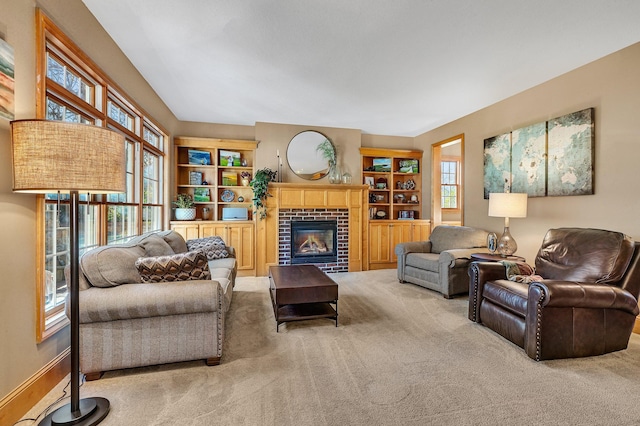 living room featuring a brick fireplace and carpet flooring