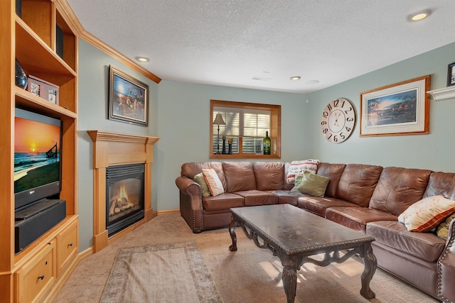 living area featuring light carpet, a textured ceiling, and a glass covered fireplace