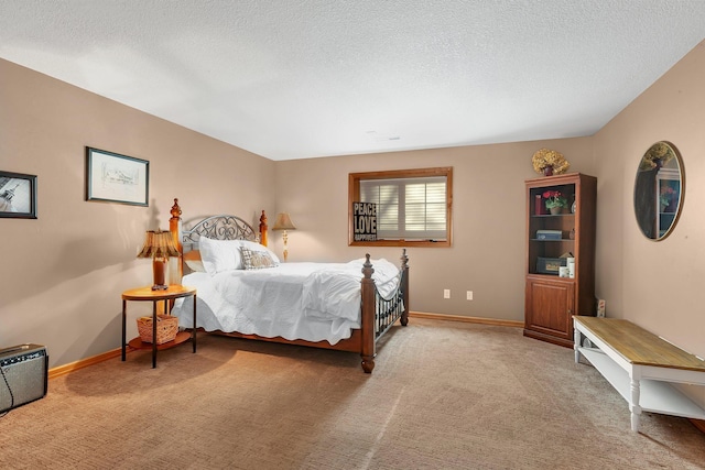 bedroom featuring carpet, a textured ceiling, and baseboards