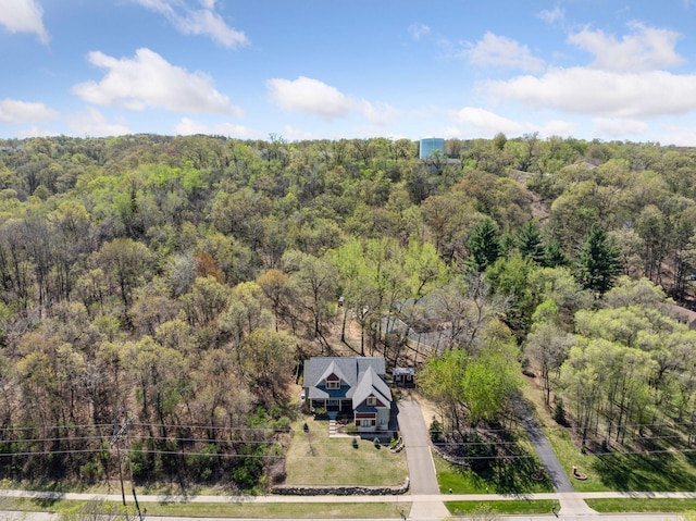 view from above of property with a heavily wooded area