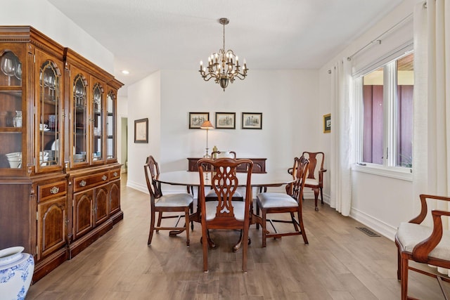 dining space featuring a chandelier, baseboards, plenty of natural light, and recessed lighting