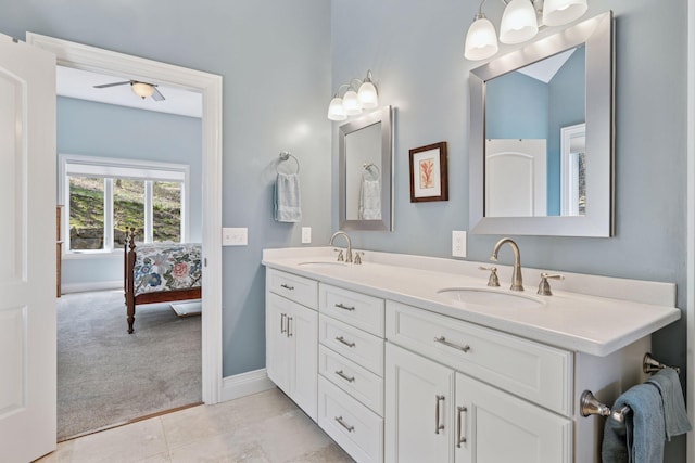 bathroom with double vanity, baseboards, and ensuite bath