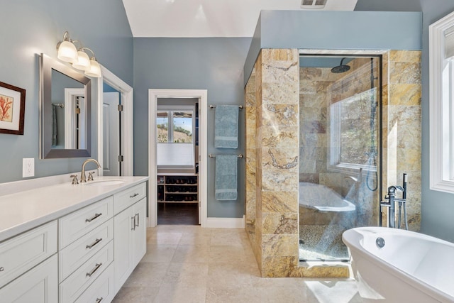 bathroom with a stall shower, vanity, and a freestanding bath